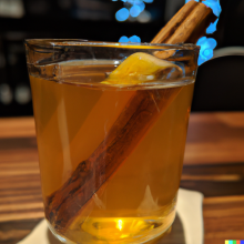Hot Toddy sitting on the counter at a bar.