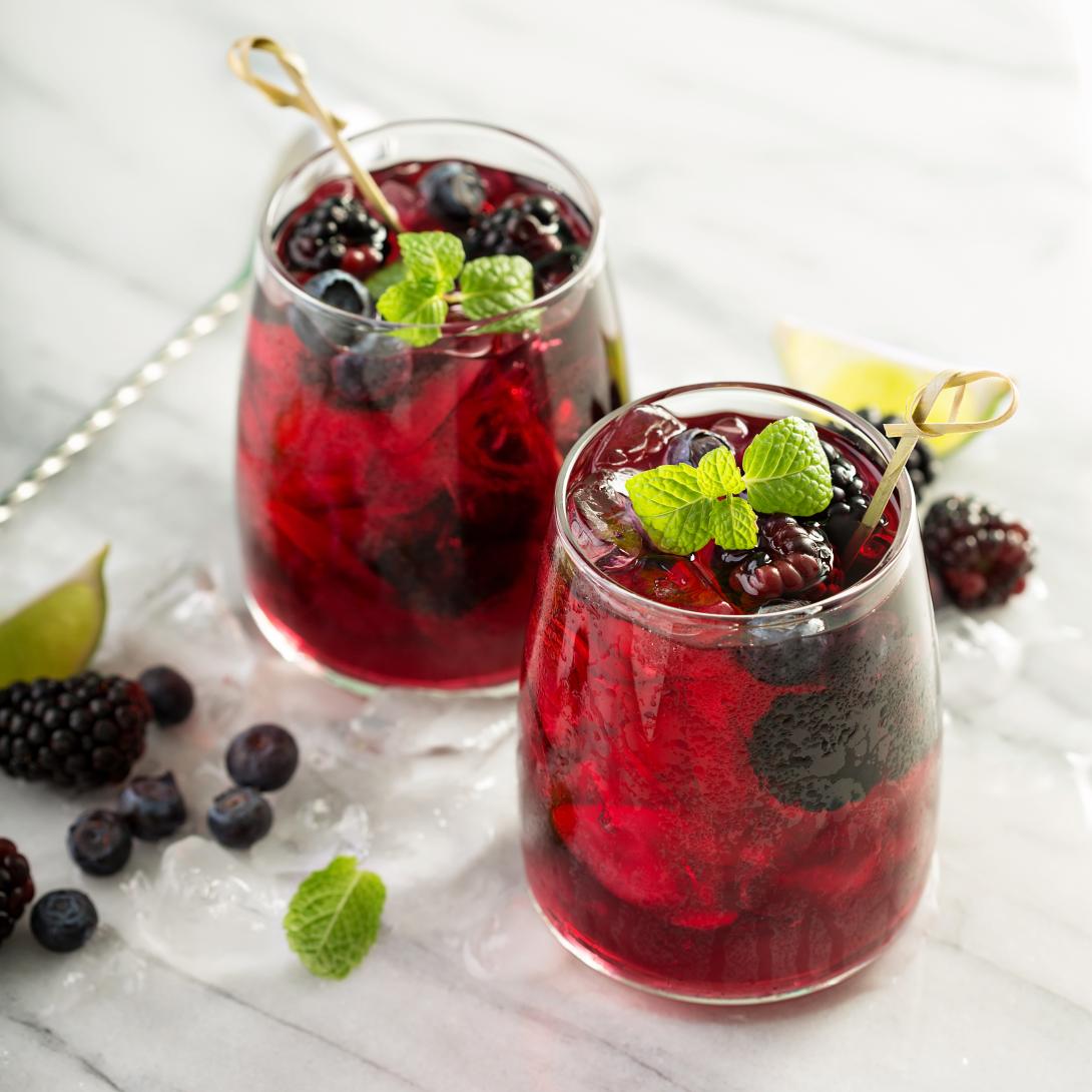 Blackberry Bourbon Smash in a Rocks Glass Garnished with Blackberries and Mint
